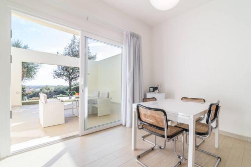 a white dining room with a white table and chairs at Villa Oleandro in Pula