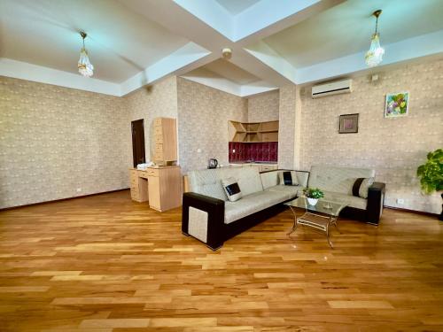 a living room with a couch and a table at Nur Hotel & Terrace Cafe in Baku