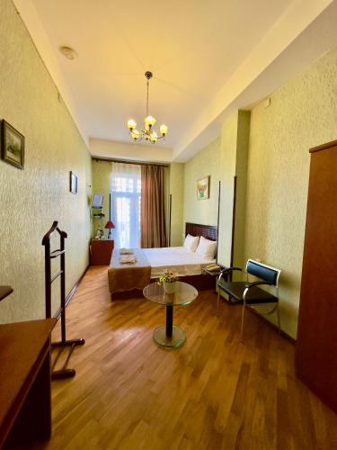 a hotel room with a bed and a living room at Nur Hotel & Terrace Cafe in Baku