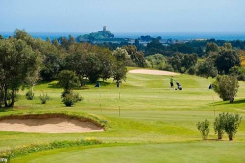 a view of a golf course with a golfer on the green at Villa Oleandro in Pula