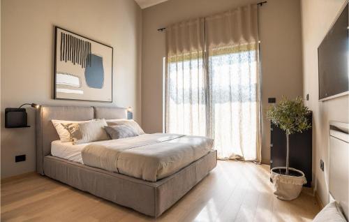 a bedroom with a bed and a large window at Villa Silente in Bale