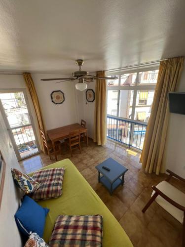 トレモリノスにあるApartamentos Playa Bajondilloの緑のソファとテーブルのあるリビングルーム