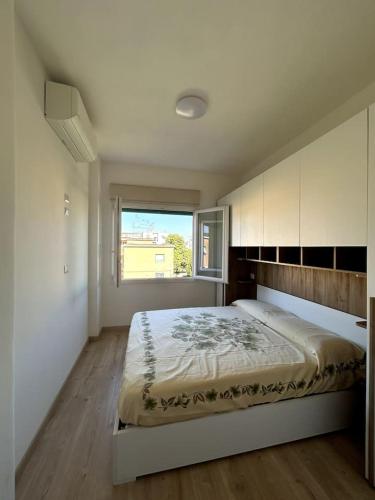 a bedroom with a large bed and a window at Nicolosi Apartment in Latina