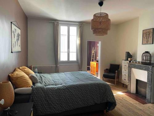 a bedroom with a bed and a fireplace at Albi centre ville -piscine view our profile please in Albi