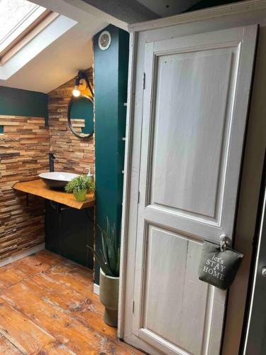 a bathroom with a door leading to a sink at Albi centre ville -piscine view our profile please in Albi