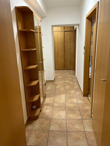 a hallway with a door and shelves and a hallway with a hallwayngth at Apartmány Formanka na náměstí in Hustopeče