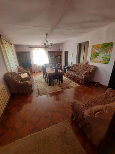 a living room with couches and a table and chairs at MyhomeIsYourhome in Hors