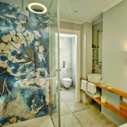 a bathroom with a shower and a toilet at Piccolo Hotel in Terracina