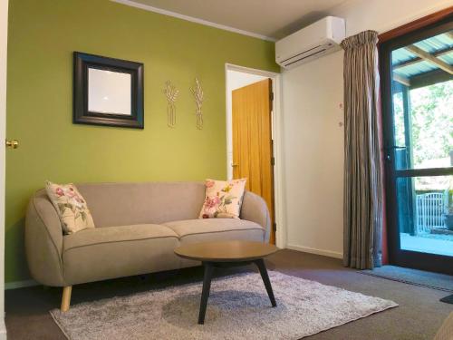 a living room with a couch and a table at Alpine View Lodge in Wanaka