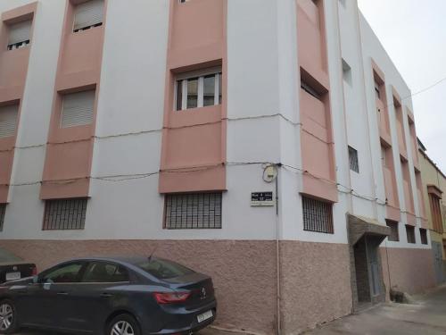 a black car parked in front of a building at Flat Al farabi in Agadir
