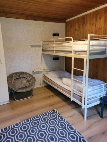 two bunk beds in a room with a rug at Karlstorp 4 km från Vimmerby in Vimmerby