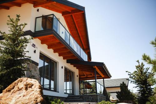 a house with a balcony on the side of it at EcoBerghaus - Котеджне містечко in Bukovel