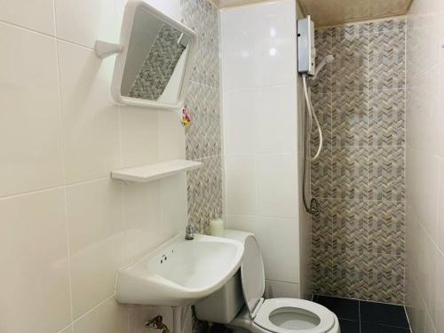 a small bathroom with a toilet and a sink at Condo popular T8 fl.12 in Thung Si Kan