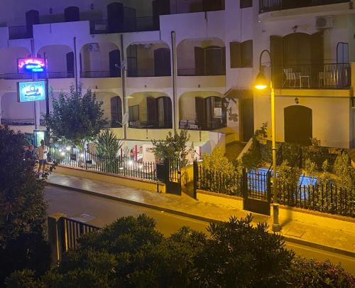 a city street at night with a building at Le Ancorette in Giardini Naxos