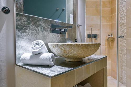 a bathroom with a sink and a counter with towels at Strandvogtei Sylt in Rantum