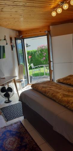 a bedroom with a bed and a desk and a window at Studio in Domat Ems in Ems