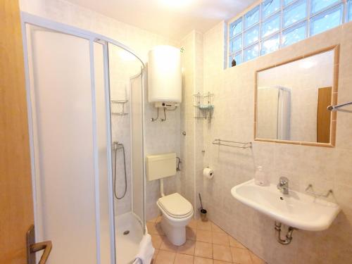 a bathroom with a toilet and a sink and a shower at Apartments Mostak in Baška