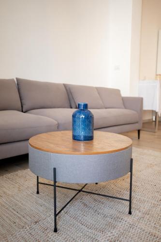 a blue vase sitting on a coffee table in front of a couch at Ca’ Lezet in Guagnano