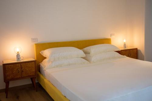 a bedroom with a bed with two lamps on tables at Ca’ Lezet in Guagnano