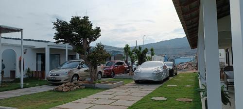 two cars parked next to a house with a tent at Myhoa Lagoon - Kiting Town in Phan Rang