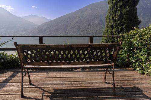 a wooden bench sitting on top of a wooden boardwalk at Casamia Juliette in Valsolda