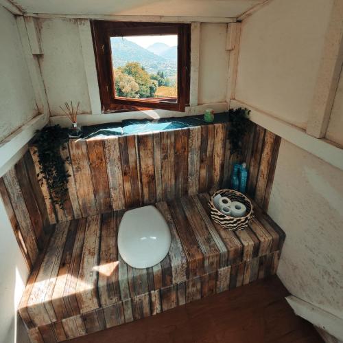 an overhead view of a toilet in a room with a window at Rucăr Glamping Village in Rucăr