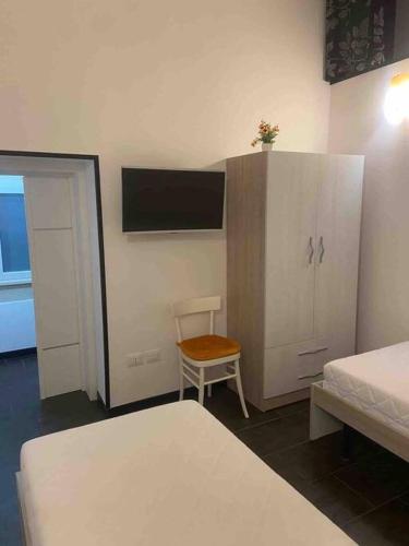 een slaapkamer met een bed, een kast en een stoel bij La Casa Turchina a 3 km da Otranto in Giurdignano