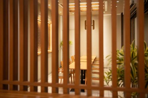a wooden fence with a table and chairs in a room at Shizuoka Town Hotel in Shizuoka