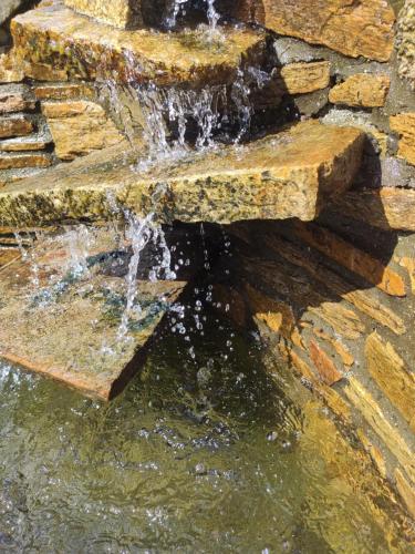 a stone fountain with water pouring out of it at Casa Faustino in A Coruña
