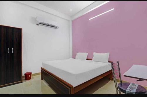 a bedroom with a white bed and a chair at Spot ON HOME 81265 Hotel Sitasmriti in Phāphāmau