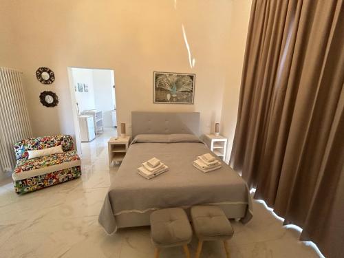 a small bedroom with a bed and a chair at Allegra Viareggio Appartamento & Affittacamere Guest house in Viareggio