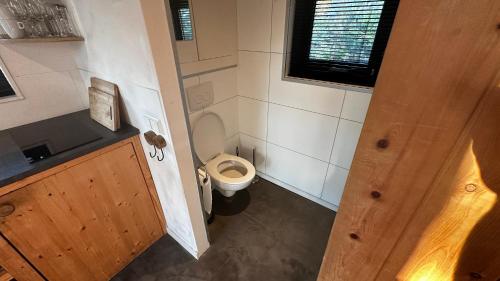 an overhead view of a small bathroom with a toilet at TinyStay Veluwe in Otterlo