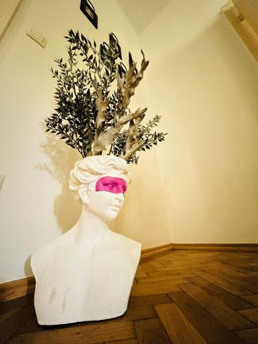 a statue of a woman with pink glasses in a room at Apartment 5 min Schönbrunn Gloriette, Direct to City Center, Free Parking in Vienna