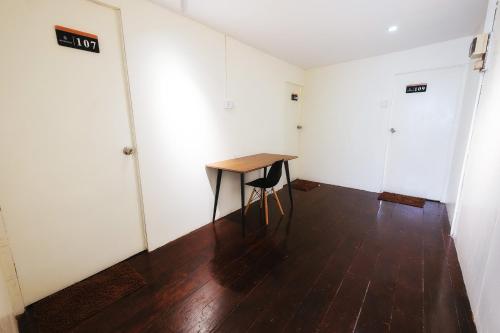 a room with a table and a chair in it at monstera homestay (Lenggong) in Kampong Ulu Jepai
