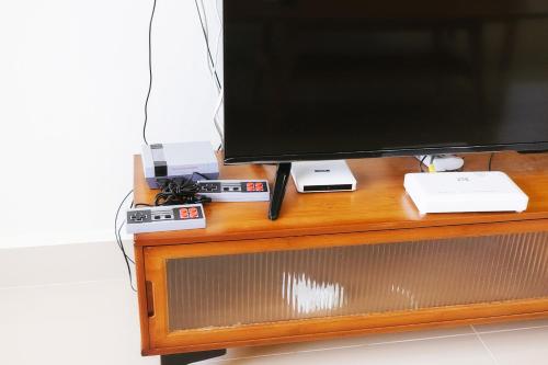 a television sitting on top of a wooden entertainment center at monstera homestay (Lenggong) in Kampong Ulu Jepai