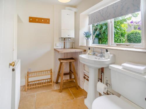 a bathroom with a sink and a window at Lavender Cottage in Helmsley