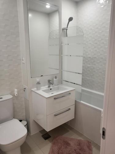 a white bathroom with a toilet and a sink at Hils Pallady Apartment Lyly in Bucharest