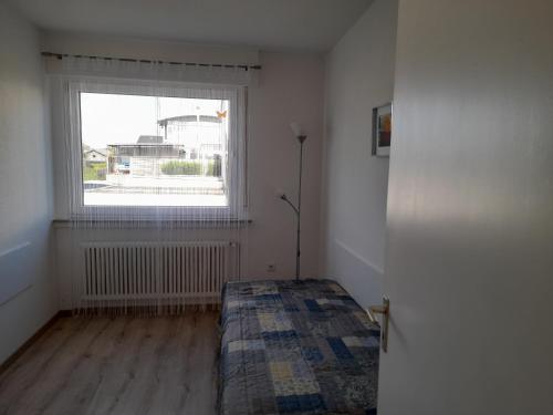 a bedroom with a bed in front of a window at Ferienwohnung in Lemgo-Brake, 3 Zimmer in Lemgo