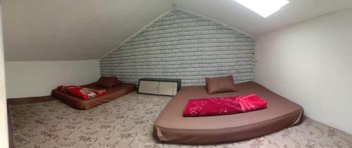 Tempat tidur dalam kamar di DIENG GHUZY HOUSE syariah family room