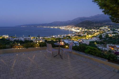 a table and chairs sitting on top of a roof at Blue View Villas in Stalida