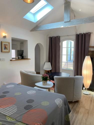 a living room with a bed and a table and chairs at Studio indépendant, front de mer et plage à 200m in Antibes