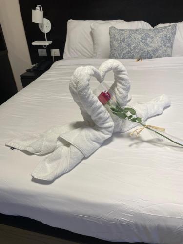 two swans made out of towels on a bed at Mizirawi Historic Hotel in Ramallah