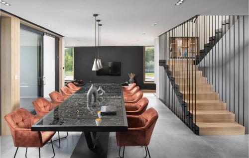 a dining room with a black table and leather chairs at Villa Carbon Residence in Labin