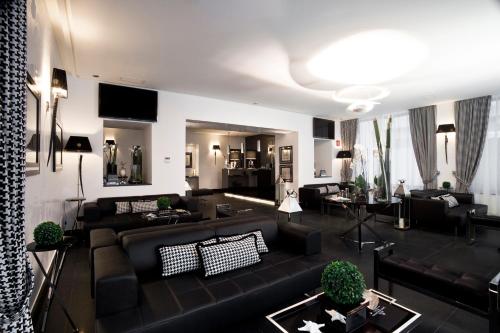 una sala de estar con sofás y mesas negros. en LHP Hotel Santa Margherita Palace & SPA, en Santa Margherita Ligure