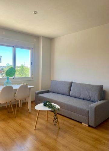 a living room with a couch and a table at Las cerezas in Ciudad Real