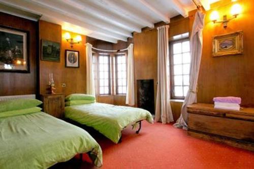 a bedroom with two beds and a window at The Tower at Plane Castle - Sleeps 4 - Pets Ok in Stirling