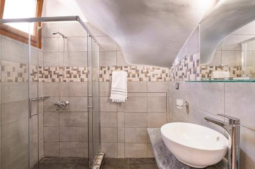 a bathroom with a sink and a shower at Blue studio in kantouni in Kokkari