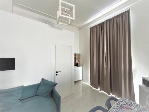 a living room with a couch and a window at Allegra Viareggio Appartamento & Affittacamere Guest house in Viareggio