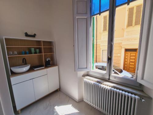 a kitchen with a large window and a radiator at Allegra Viareggio Appartamento & Affittacamere Guest house in Viareggio