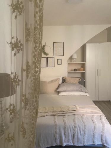 a bedroom with a white bed and a staircase at MAISON REBECCA in Carpi